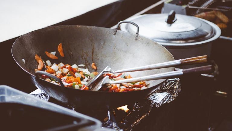 Frying vegetables in a wok